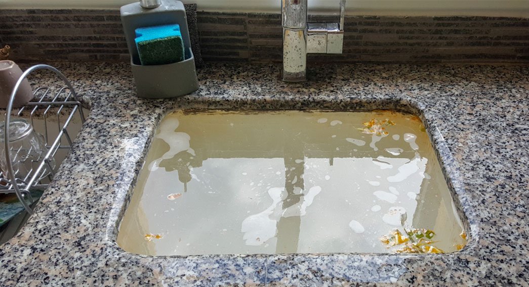 kitchen sink backing up deu to waster food and grease buit up in side the drain line