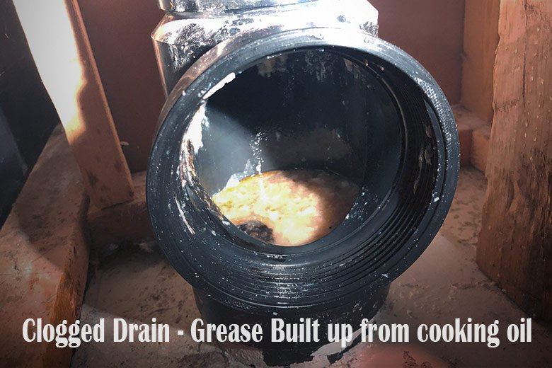 clogged-drain-line-as-grease-built-up-from-cooked-oil-drain-into-kitchen-sink-in-toronto