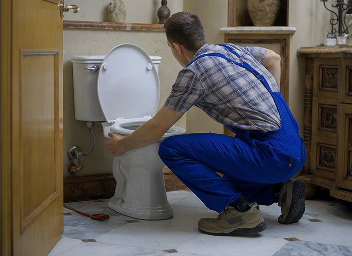 Licensed toronto plumber repairing toilet drain
