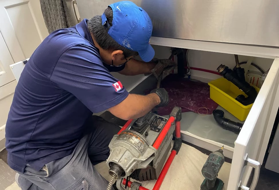 Toronto plumber snaking the drain line